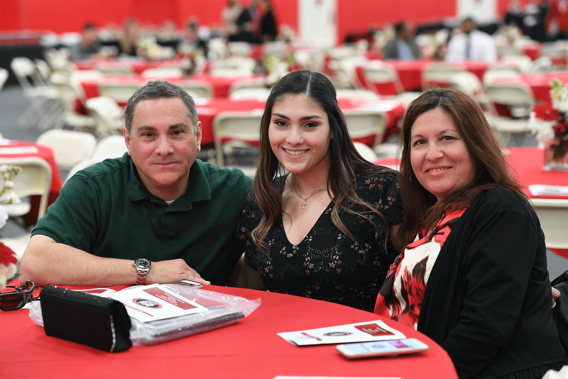 Parents with their student at a table.