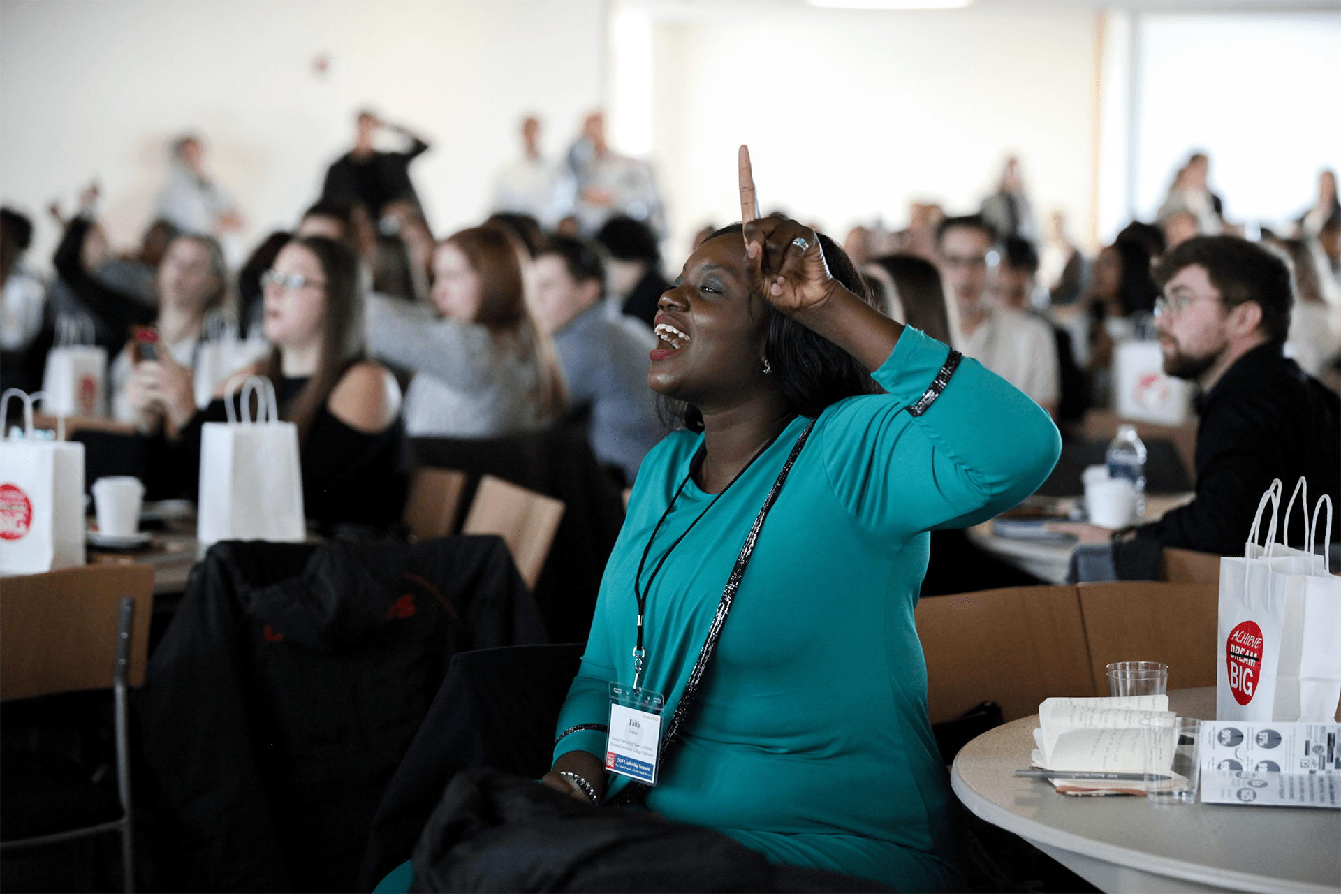 NSLS Member raising their hand at a conference.