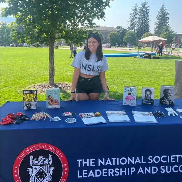 NSLS Intern at a Booth.